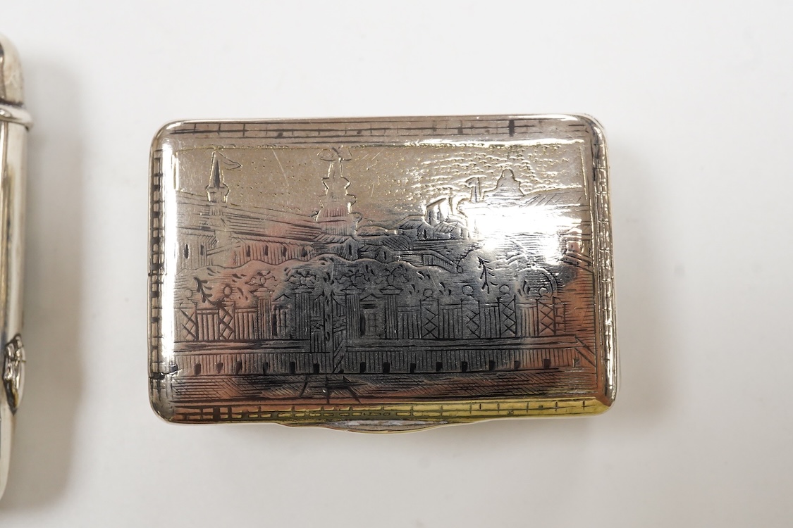 A Japanese white metal and polychrome enamel vesta case, decorated with flowers and butterfly, 56mm, together with a 19th century Russian 84 zolotnik and niello snuff box(tired), a modern silver pill box and a silver mou